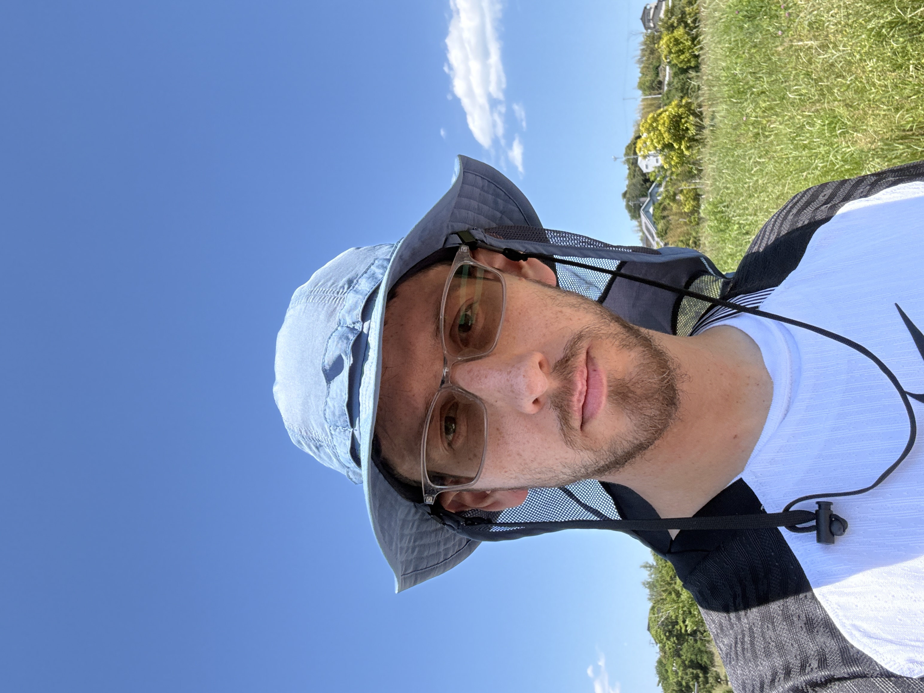 Picture of me staring into the camera, background is blue sky with no clouds